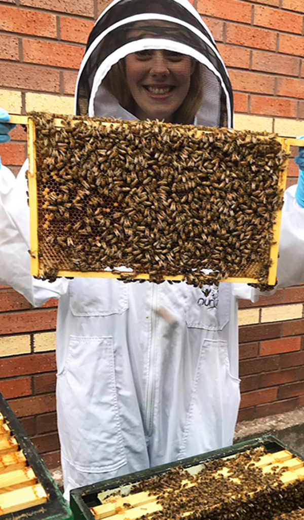 Lady holding honeycomb